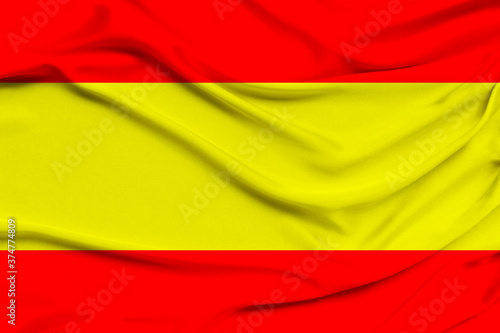 beautiful photo of the national flag of Spain on delicate shiny silk with soft draperies  the concept of the country s national life  horizontal  closeup  copy space
