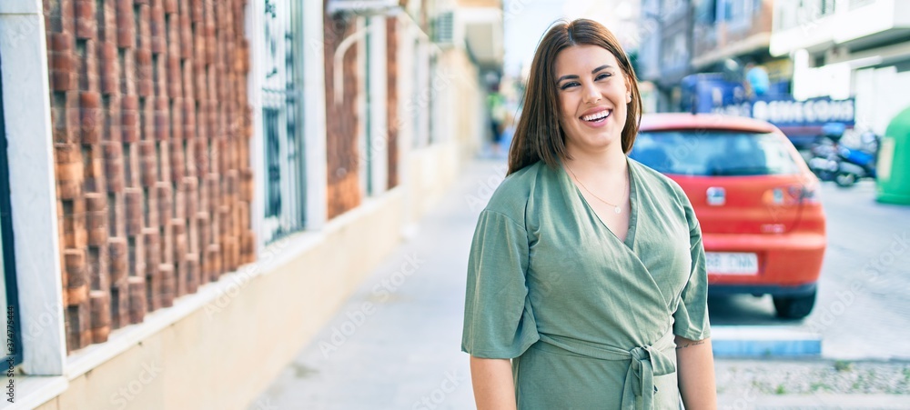 Young hispanic woman smiling happy walking at street of city