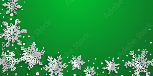 Christmas background with volume paper snowflakes with soft shadows on green background