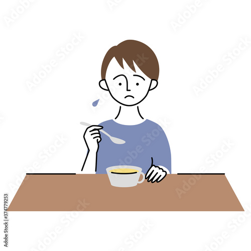 美味しくなさそうに食事をする男の子
