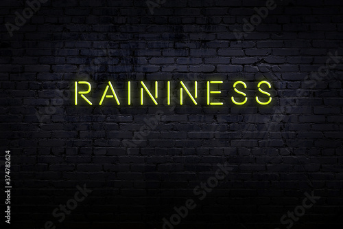 Night view of neon sign on brick wall with inscription raininess photo