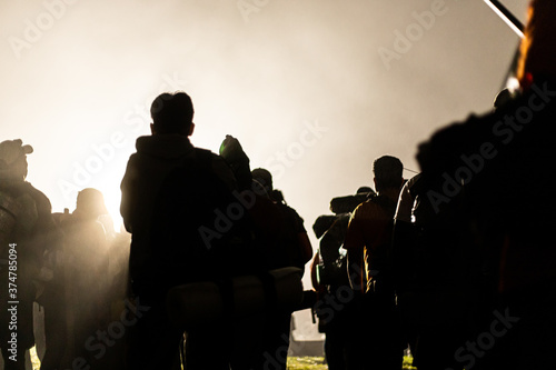 Group of men silhouette with foggy backlight © DogmaDS