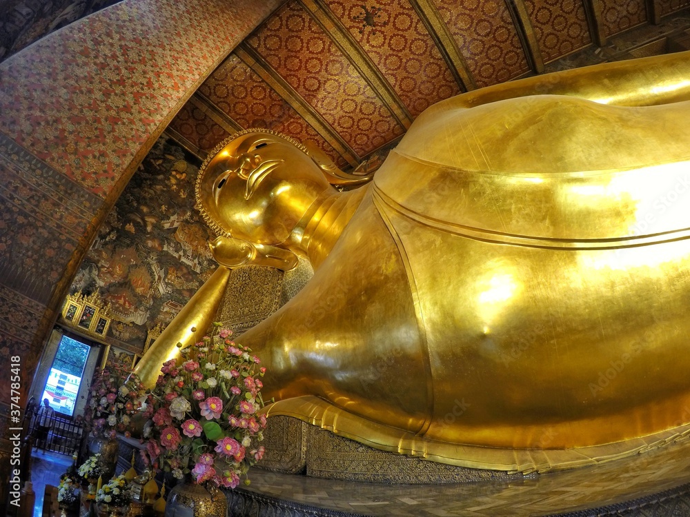 Reclining Buddha at Wat Pho also spelled Wat Po, is a Buddhist temple in Bangkok, Thailand.