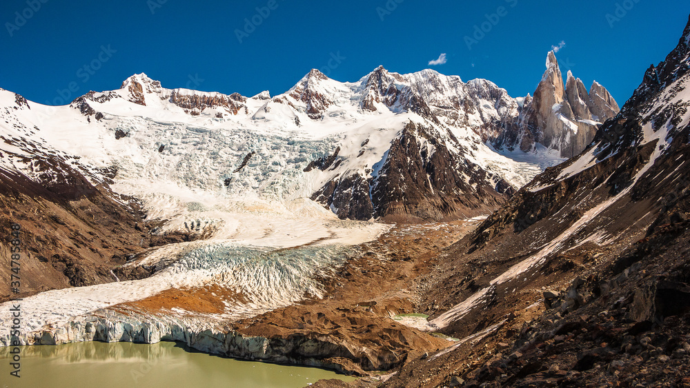 Glacier and Cerro Torre in Argentinian Patagonia. Colourful landscape of snowy mountains, rocks, lake and beautiful environment.