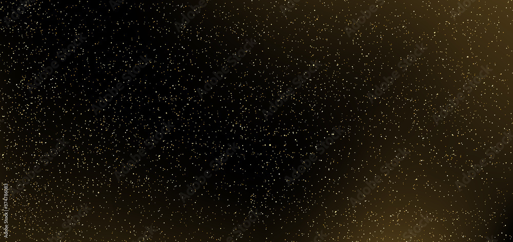 Gold glitter on black background. Many golden dots particles in darkness.