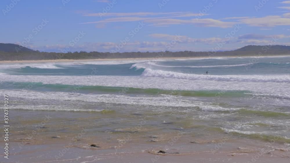 Ocean Waves On A Sandy Beach - Surfing At Crescent Head During Summer - Sydney, New South Wales, Australia. - panning shot Ocean Waves On A Sandy Beach - Surfing At Crescent Head During Summer - Sydney, New South Wales, Australia. - panning shot