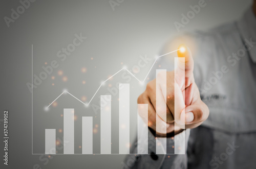 Businessman present a graph of profit growth and chart.Hands are touching financial graph plan