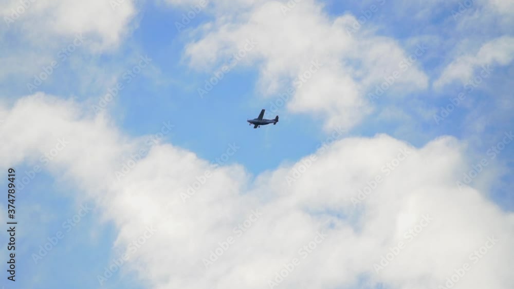 Follow Shot of Small Airplane Flying with a Blue Sky and Clouds in Background Follow Shot of Small Airplane Flying with a Blue Sky and Clouds in Background