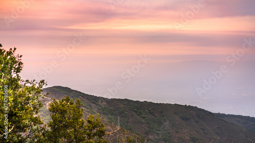 Sunset views in Santa Cruz mountains; Smoke from the nearby burning wildfires, covering the entire sky and San Jose, barely visible in the valley; South San Francisco Bay Area, California