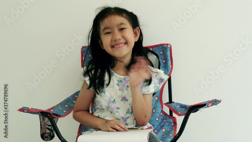 Happy Asian little girl smile on the face, Asia child hold book