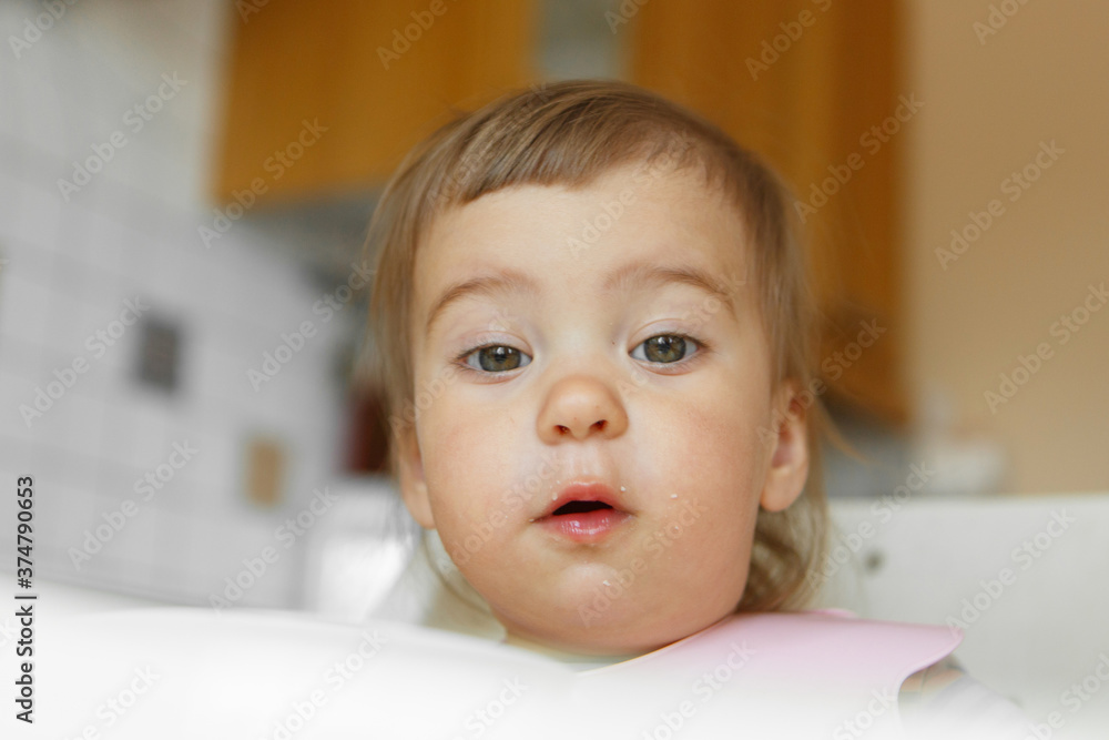 portrait of a child who smeared face with food portrait of a child who smeared face with food