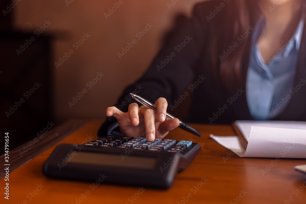 Fototapeta premium Business women working with calculator and business document on office table in office. finance accounting concept.
