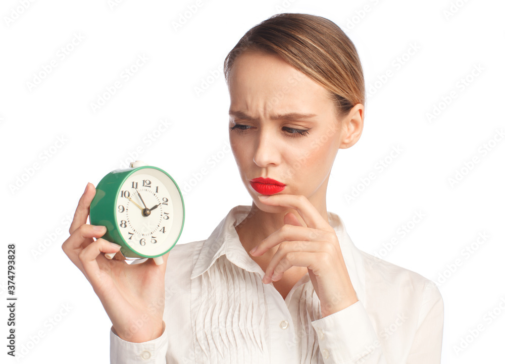 thoughtful frowning woman with alarm clock isolated on white background, business concept thoughtful frowning woman with alarm clock isolated on white background, business concept