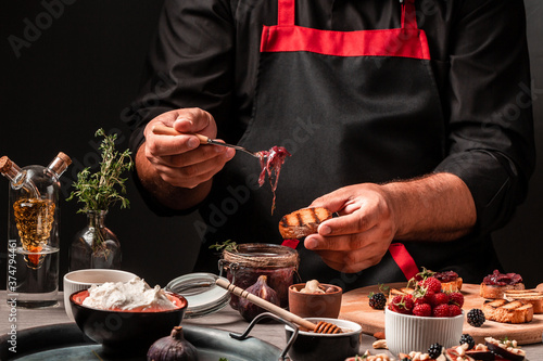 Canvastavla chef cook hands with Bruschetta or ctostini with caramelized onions, blue cheese