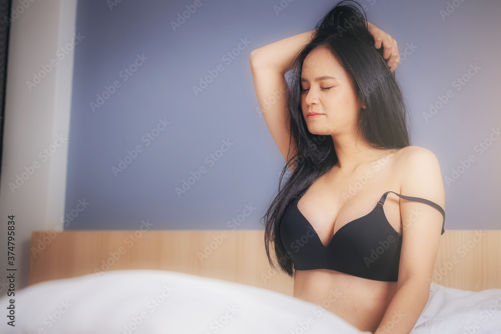 Sexy Asian woman in underwear sitting stretching and relax at bedroom in the morning enjoy with her weekend Sexy Asian woman in underwear sitting stretching and relax at bedroom in the morning enjoy with her weekend