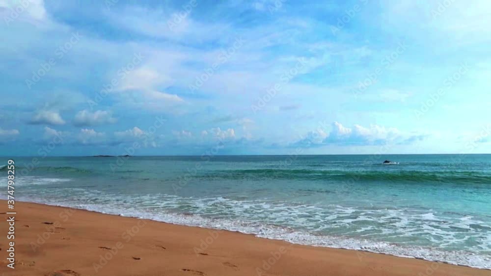 Panoramic view of Beautiful sea water & calm ocean wave foam reaching tropical summer golden sandy beach on white cloud blue sky background in sunny sunlight & sun ray, cinemagraphs b-roll Slow Motion Panoramic view of Beautiful sea water & calm ocean wave foam reaching tropical summer golden sandy beach on white cloud blue sky background in sunny sunlight & sun ray, cinemagraphs b-roll Slow Motion