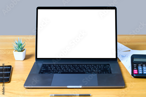 Blank screen laptop computer on wood table with clipping path. business concept. Mockup with copy space.