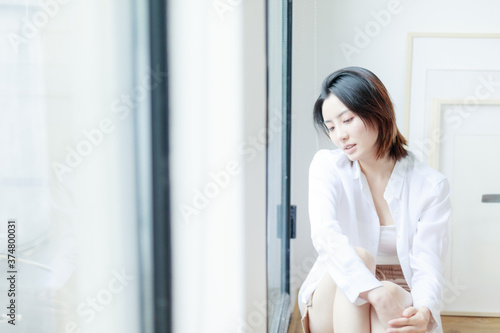 Beautiful young women sitting by the window of Asia