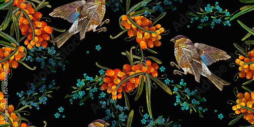 Sea buckthorn berries branch, meadow herbs and birds. Horizontal seamless pattern. Autumn embroidery design. Fashion template for clothes, tapestry. Fall garden art