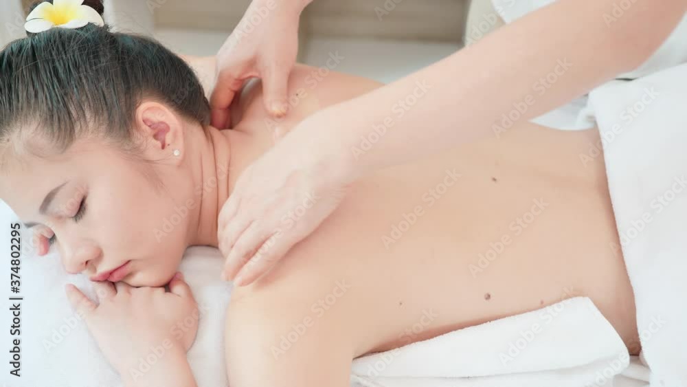 Young Asian woman getting Relaxing oil massage at beauty spa salon. Back massage, Massage for health. Dolly slider