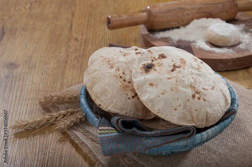Indian bread (Roti) on a wooden base along with the props.
