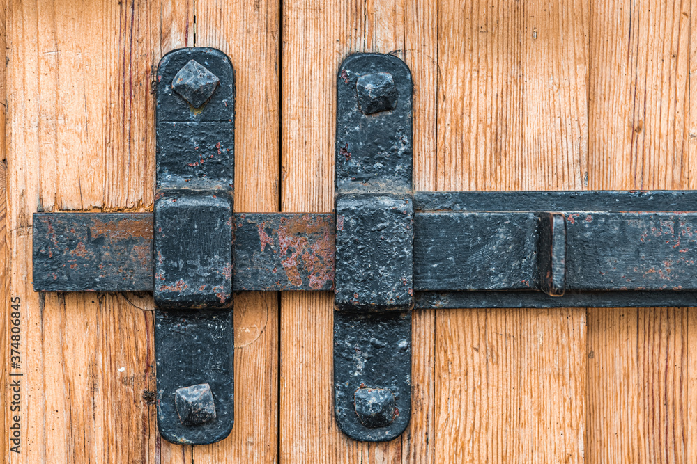 Wrought-iron latch on the wooden gate Wrought-iron latch on the wooden gate