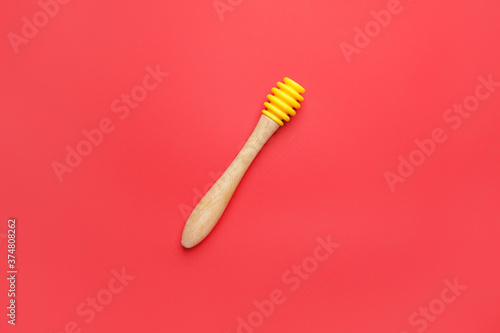 Honey dipper on color background