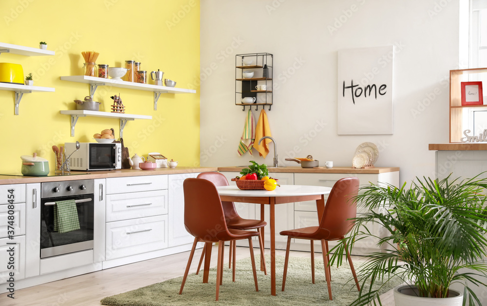 Fototapeta premium Interior of stylish modern kitchen with dining table