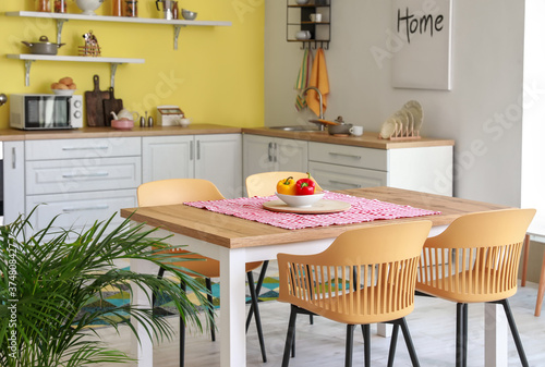 Dining table in interior of modern kitchen