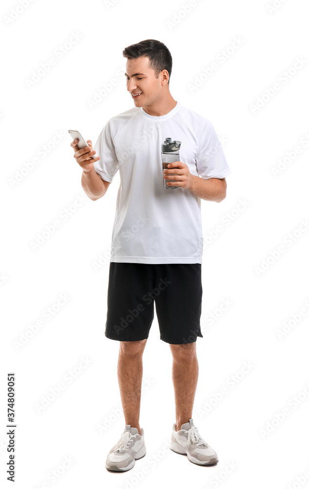 Sporty young man with bottle of water and phone on white background Sporty young man with bottle of water and phone on white background