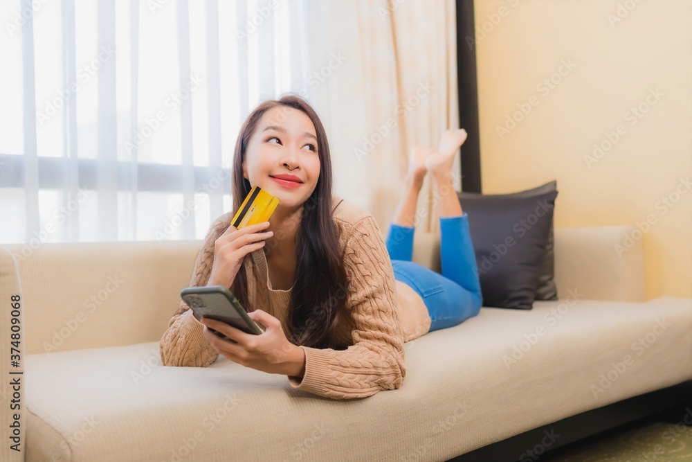 Portrait beautiful young asian woman use smart mobile phone with credit card Portrait beautiful young asian woman use smart mobile phone with credit card