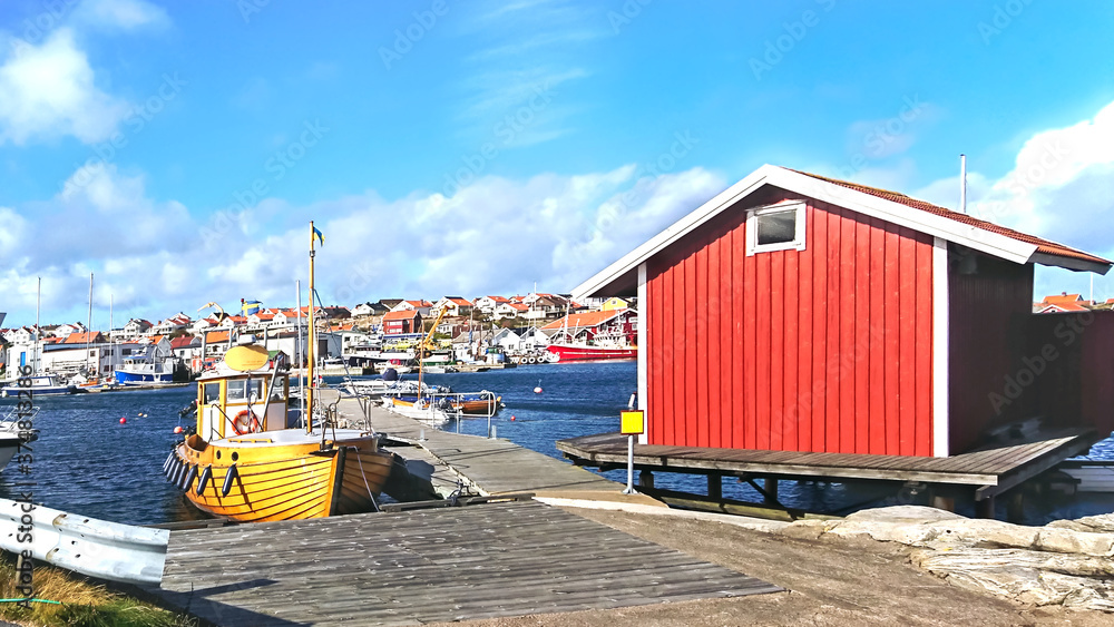 Obraz premium Boats in the harbor by a small fishing village on the shores of the North Sea, Sweden.