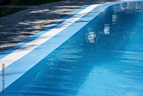 The surface of the water in the blue swimming pool.