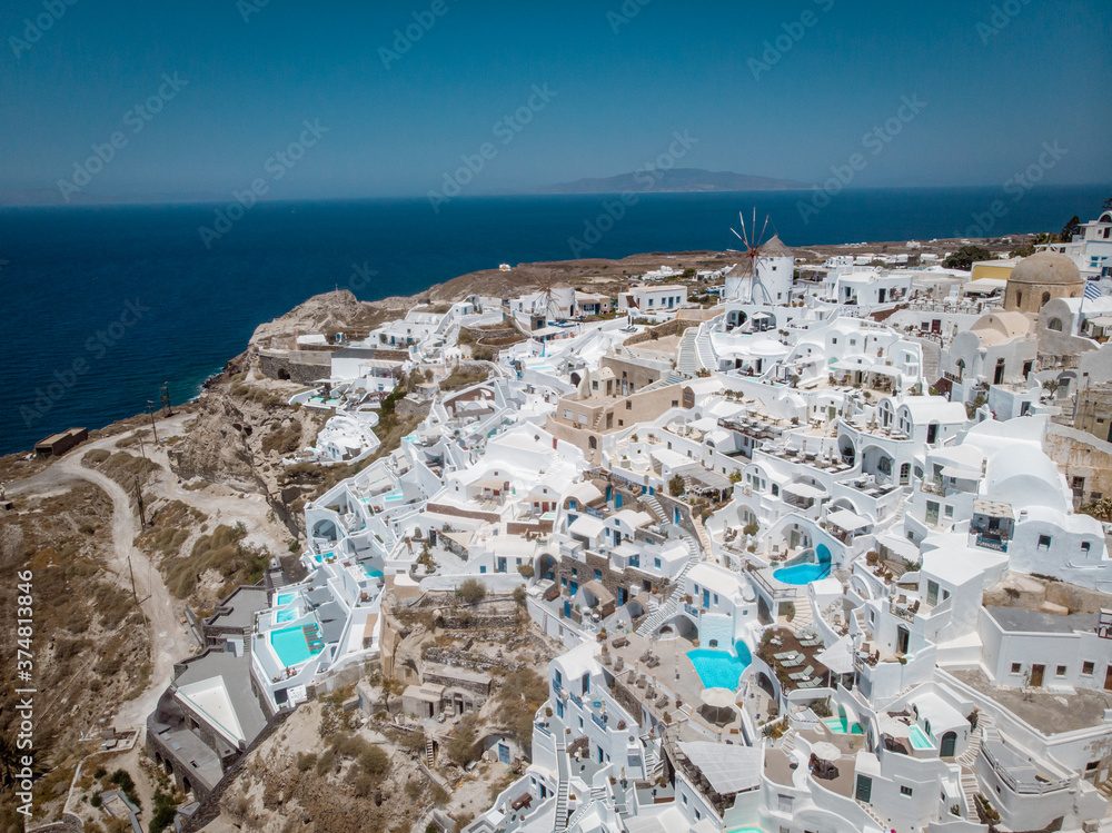 Foto Stock Drone view over Santorini, aerial view over the whitewashed  village of Oia with luxury vacation resort with infinity pools in Santorini  Greece. Europe | Adobe Stock