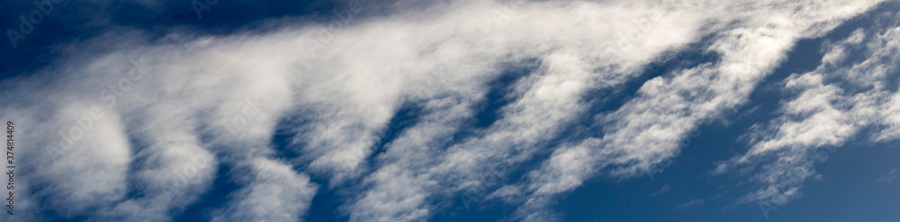 Fototapeta premium High white wispy cirrus clouds with cirro-stratus in the blue Australian sky in late winter sometimes called mare's tails indicate fine weather now but stormy changes coming within a couple of days.