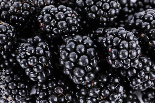 Tasty ripe blackberries as background, top view