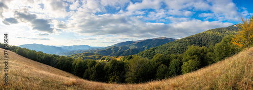 mountainous countryside in the afternoon. beautiful panorama of carpathians. valley of borzhava ridge in the distance. clouds on the sky. sunny weather