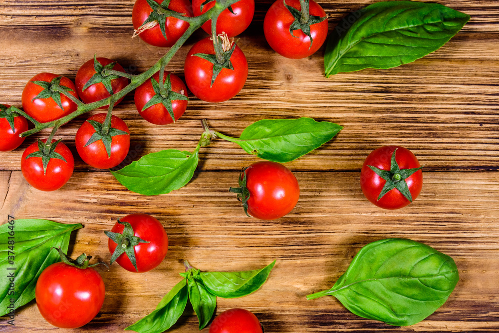 Heap of small cherry tomatoes on wooden table. Top view Heap of small cherry tomatoes on wooden table. Top view