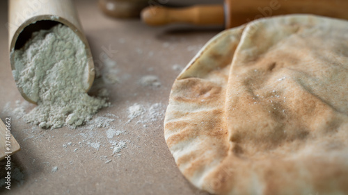 Kuboos or khubz - Arabic bread on a brown table in the kitchen photo