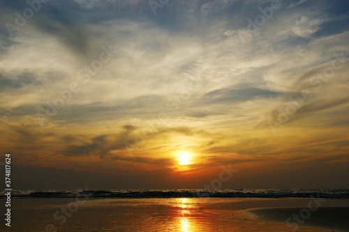 dramatic clouds. Sunset on a tropical island combined with sea and clouds in a dramatic sky