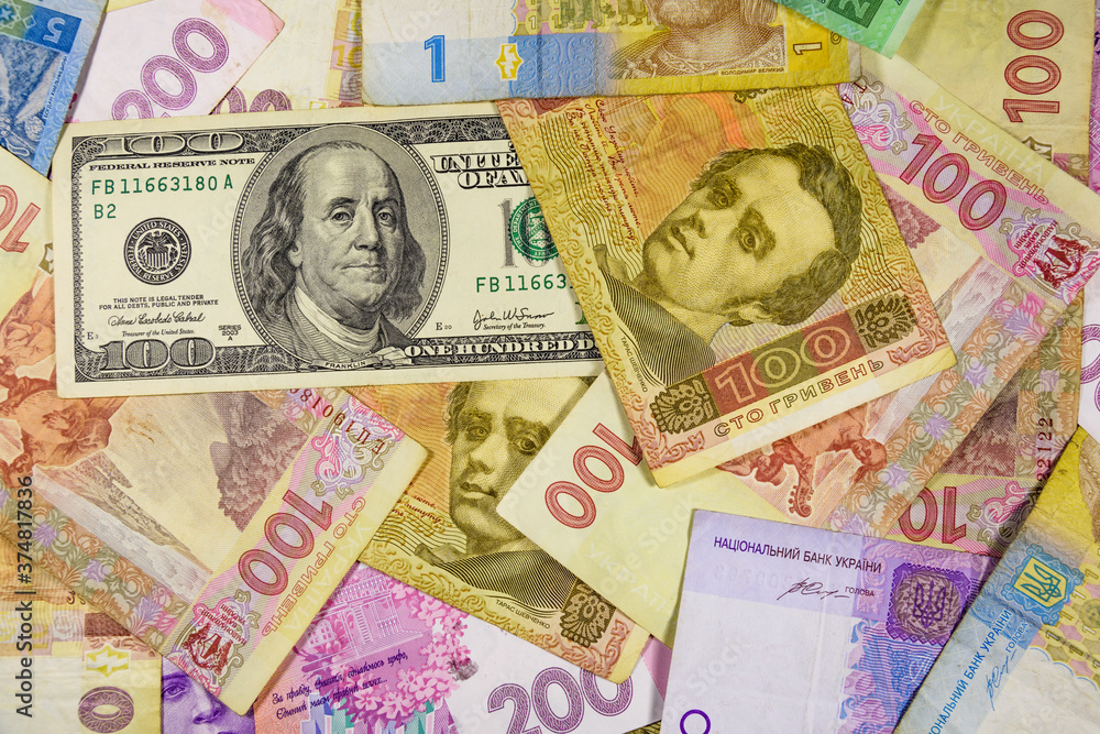 American one hundred dollars banknote on the many ukrainian hryvnas American one hundred dollars banknote on the many ukrainian hryvnas