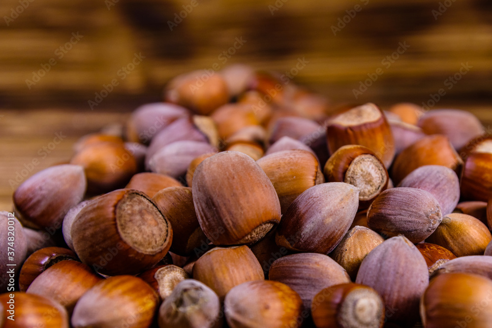 Pile of the hazelnuts on wooden table Pile of the hazelnuts on wooden table