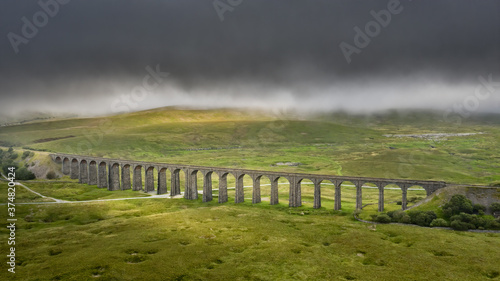 Ribblehead Viaduct North Yorkshire, train line from Settle to Carlise. drone photograph of the viaduct and countryside in low cloud. 