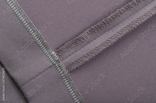 Photos details of clothing, the seam is made on a sewing machine, the sections are proc