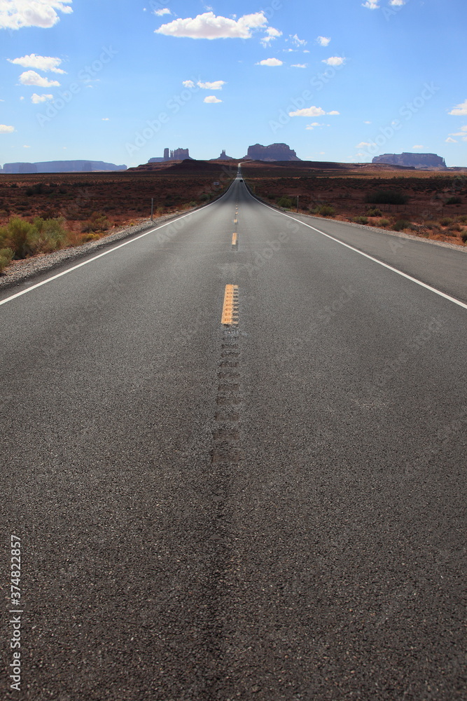 View of long road leading towards Monument Valley seen from Forrest Gump Point in Utah, USA
