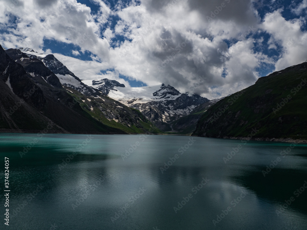 Scenic view on Mooserboden See near Kaprun, Austria, Europe. National park Hohe Tauern. Charming lake with amazing deep colorful water and glaciers above it. Favourite destination for holidays.
