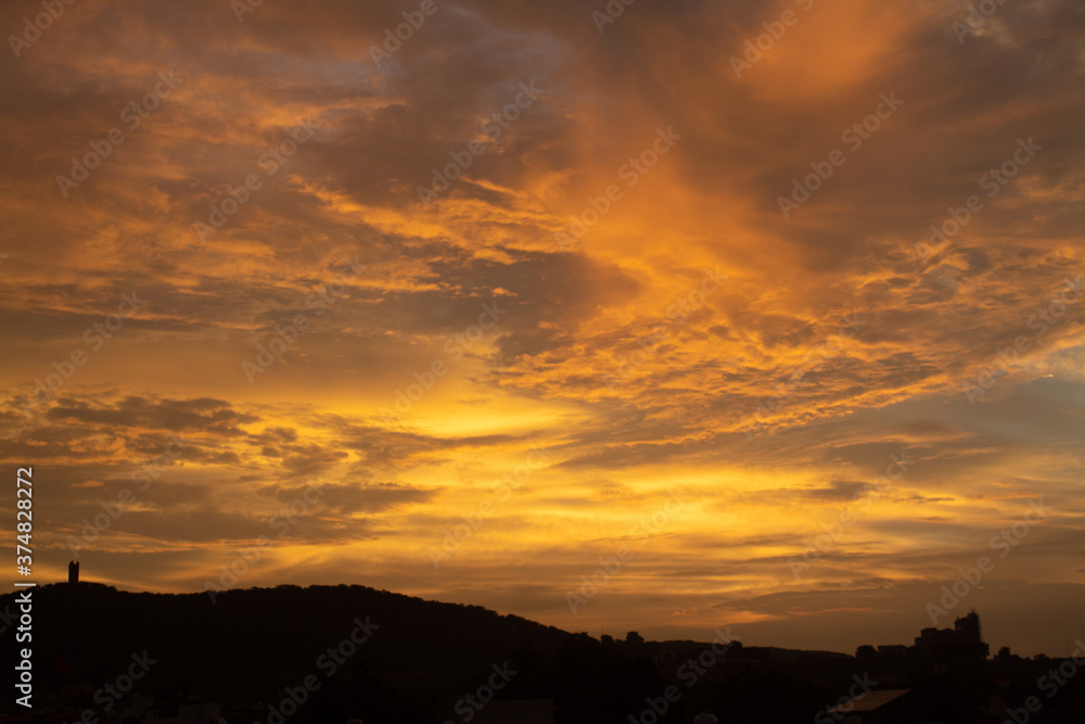 Beautiful clouds above the hill during the sunset