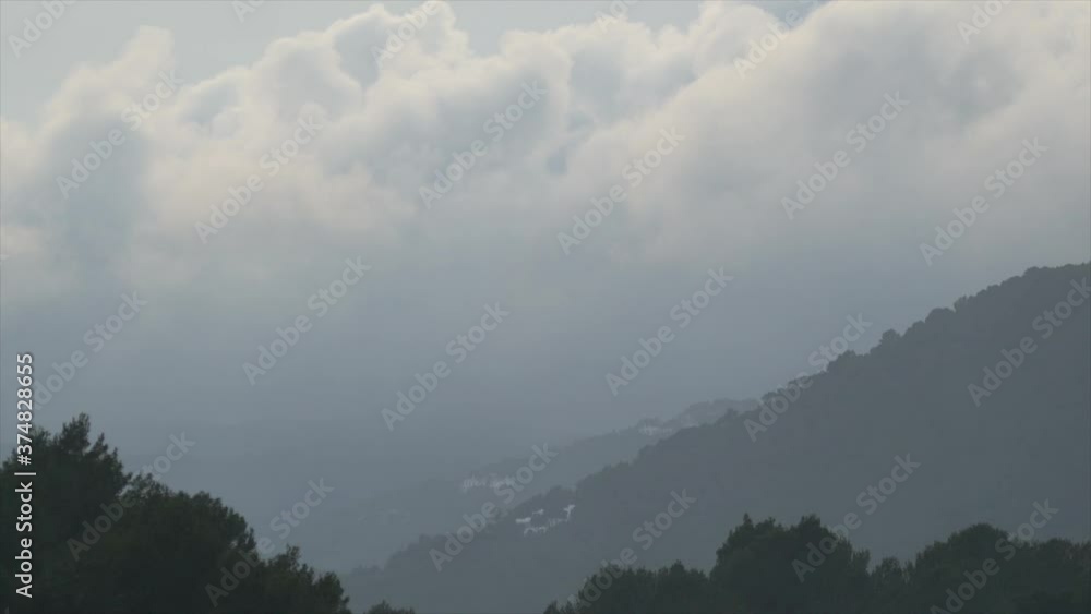 big clouds moving between mountains big clouds moving between mountains