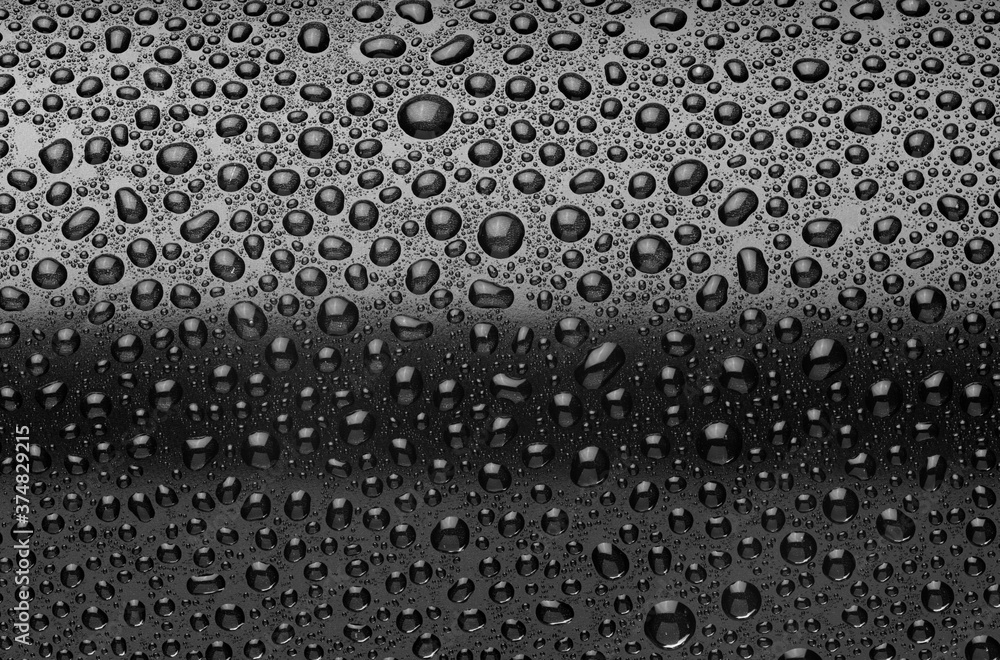 Black aluminum can with water drops macro shot.