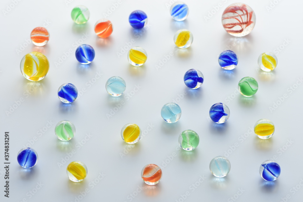 Fototapeta premium Colorful glass marbles on white background.
